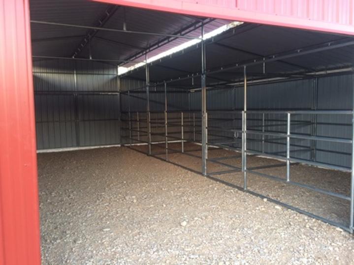 METAL BARN WITH PIPE CORRAL INTERIOR